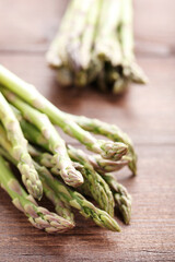 Green asparagus on brown wooden table