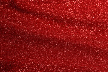 Shiny red fabric with pleats. Abstract red background