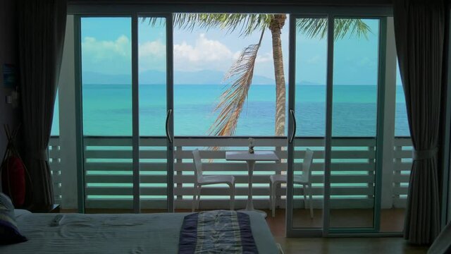 Sea and palm tree view from hotel room