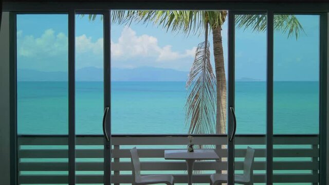 Sea and palm tree view from hotel room