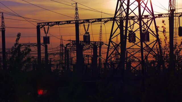 Electricity power station at a sunset, steadicam shot
