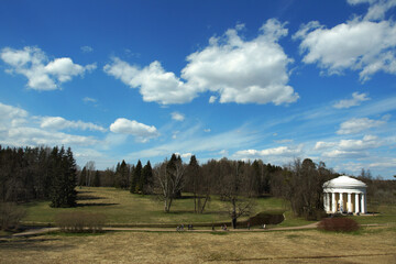 Landscape in the Pavlovsk park in autumn, beautiful classical white gazebo with columns against the...