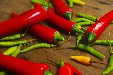 Fresh Red And Green Chili Over Wooden Background With Dramatic Light