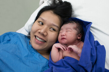 happy mom and childbirth baby asian girl