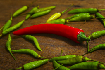 Fresh Red And Green Chili Over Wooden Background With Dramatic Light