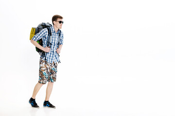 Young hiker in sunglasses with  backpack on  white background