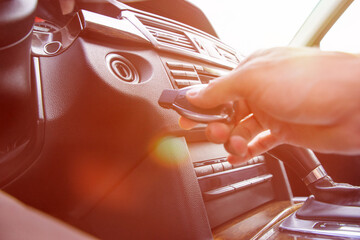 Person's Hand Inserting Key To Start Car