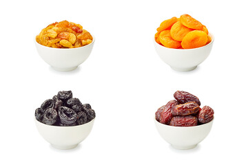 Set of bowls with dried fruits on white