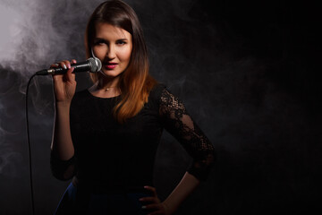 Young brunette singing in studio