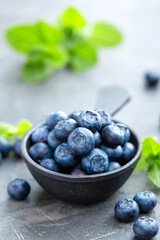 Fresh Blueberries in a bowl on dark background, top view. Juicy wild forest berries, bilberries. Healthy eating or nutrition.