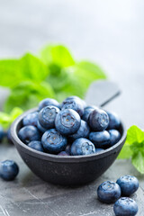 Fresh Blueberries in a bowl on dark background, top view. Juicy wild forest berries, bilberries. Healthy eating or nutrition.