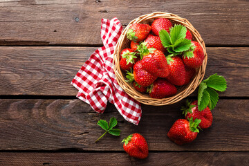 Fresh strawberry in basket on wooden rustic table, closeup. Delicious, juicy, red  berries. Healthy eating. © Sea Wave