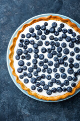 Delicious dessert blueberry tart with fresh berries and whipped cream, sweet tasty cheesecake, berry pie. French cuisine