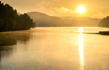 Fototapeta premium Misty sunset on the lake