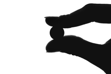 B silhouette of a hand holding a pill