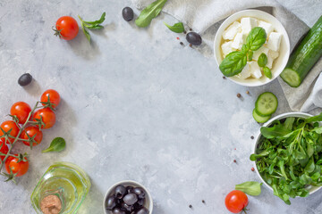 Ingredients for the preparation of Greek salad. Vitamin snack on the festive table. Top view with copy space.