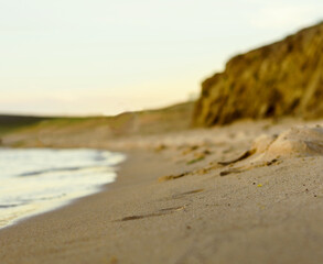 Sandy beach at sunset cloudy evening blured