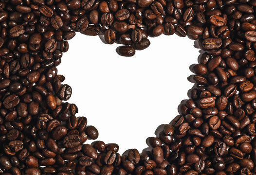 A surface of coffee beans with a free space in the form of a heart