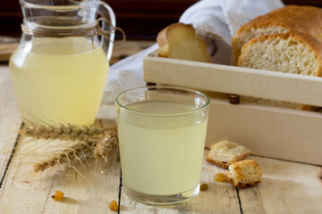 Traditional Russian cold drink light kvass on the kitchen table in a rustic style. Kvass from bread, wheat malt, sugar and water.