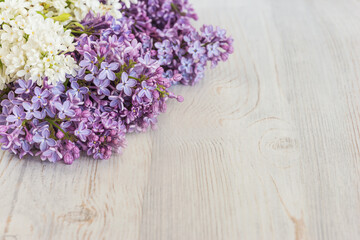 bouquet of lilac on light wooden background with space for text
