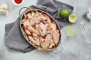 Chicken wings in spicy lime chili marinade.Overhead view 
