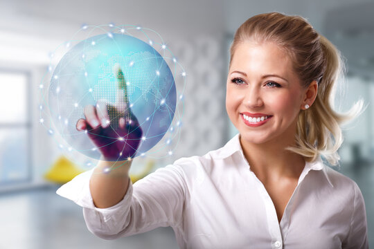 junge Frau mit holografischem Globus vor modernem Büro