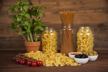 Many types of Italian pasta with fresh tomato, basil and olives