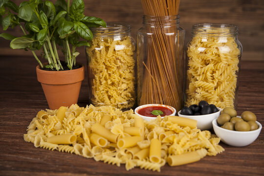 Many types of Italian pasta with fresh tomato, basil and olives