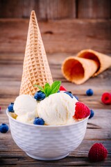 Homemade vanilla ice cream with raspberries and blueberries