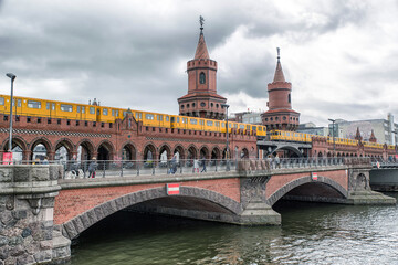 Fototapeta na wymiar Yellow train on Oberbaum bridge, Berlin
