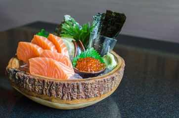 fresh salmon sashimi with salmon ikura or salmon egg and sheet of dried seaweed in bowl set on...