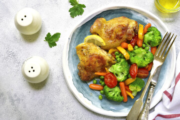 Grilled chicken thigh garnished with vegetables.Top view.