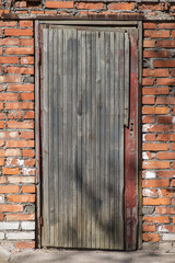 old wooden door in a brick wall