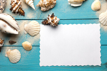 Obraz premium Marine summer postcard. Seashells on blue wooden boards in the sand on the beach