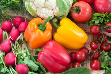Different vegetables as a tomatoes, cauliflower, peppers, radishes, cherry tomatoes 