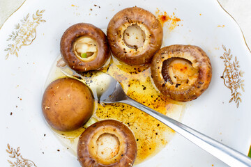 Mushrooms in a white bowl ready for grilled