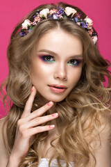 Naklejka premium Portrait of a beautiful blond girl in image of the bride with purple flowers on her head. Beauty face. Photo shot in the Studio.