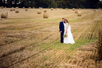 Happy newlyweds in a field