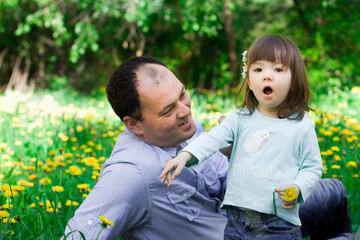 Dad with a little daughter having fun in the park.