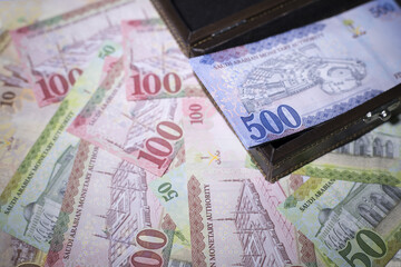 Part of Saudi riyal notes in a wooden box