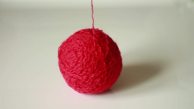 Thread from a red yarn ball