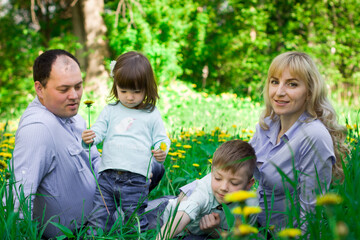 Naklejka na ściany i meble Family portrait in a spring park.