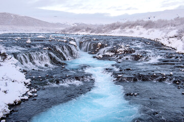 Bruarfoss waterfall in Winter cover with snow blue water from glacier. Iceland - 157146141