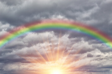Beautiful cloudy sky with rainbow and sun