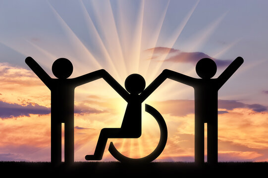 Happy disabled person in a wheelchair together with healthy people