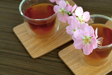 Сups of tea with blossom branch