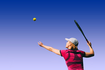 Woman playing tennis, view player against the blue sky. Tennis player on blue sky background