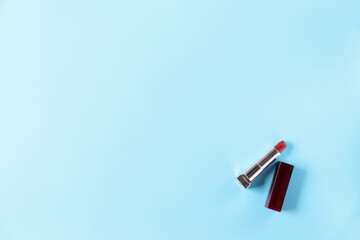 lipstick on blue background.minimal concept. Flat lay.