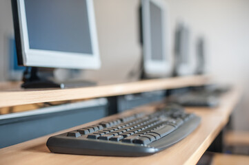 Photo of row computers in classroom or other educational institution