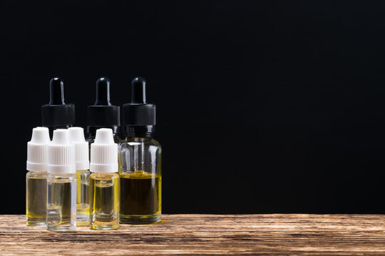 Oil in bottles for perfume, on a dark background